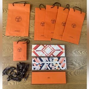 Lot of authentic Hermes shopping bags boxes and ribbon